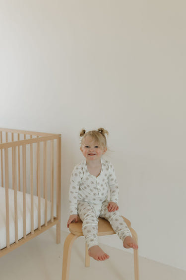Bamboo two-piece pajamas for babies in Daisy Fields design, soft and breathable for comfortable sleep.