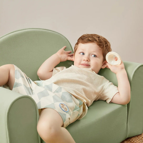 Tiny Land® GentleSnug Kid Chair in Sage, angled view showcasing its soft design and comfort for children.