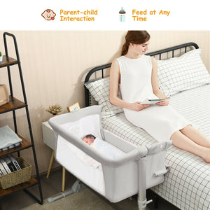 Portable baby bed side sleeper bassinet crib with carrying bag, perfect for travel and safe sleep.