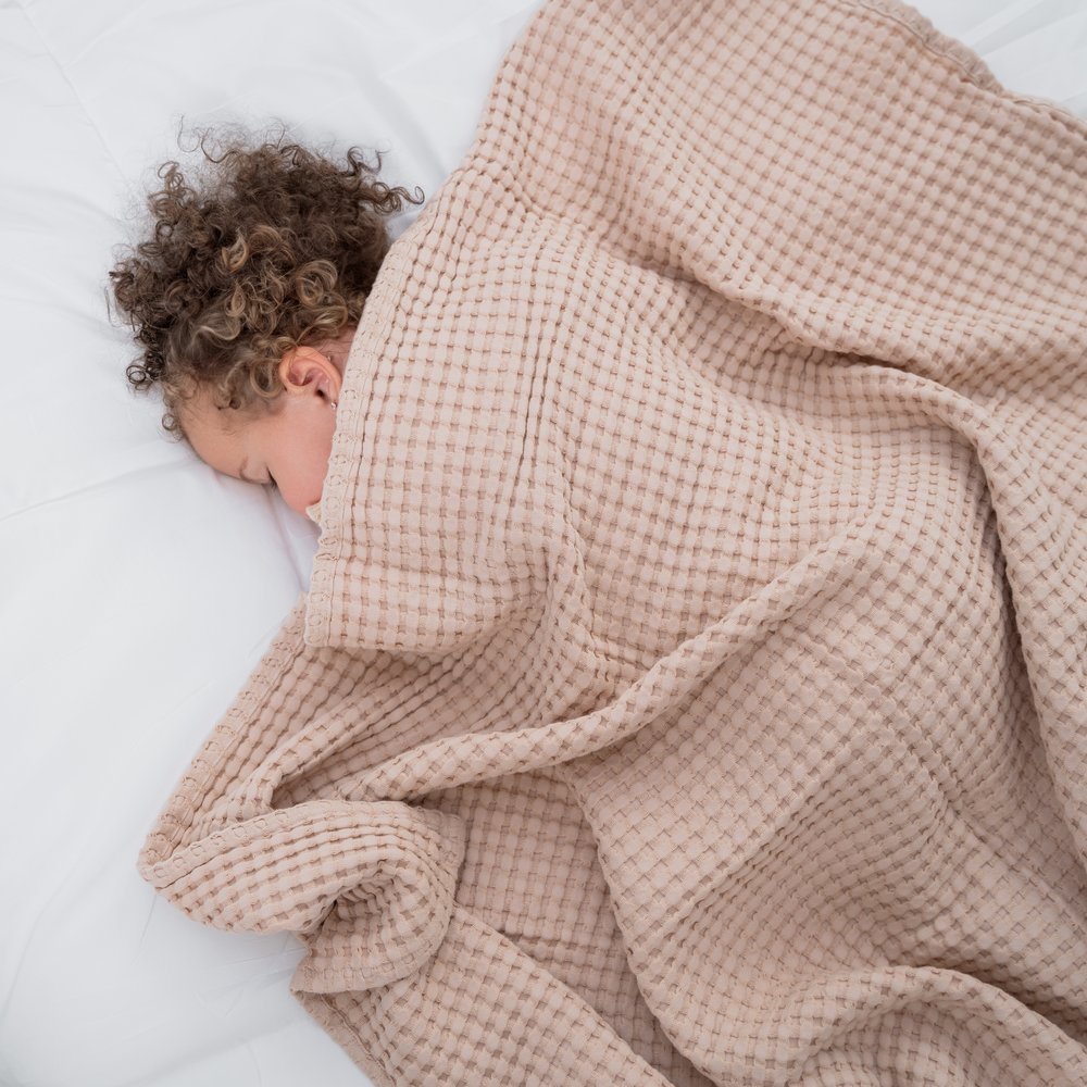 Blush baby waffle blanket, soft and cozy, perfect for swaddling and cuddling.