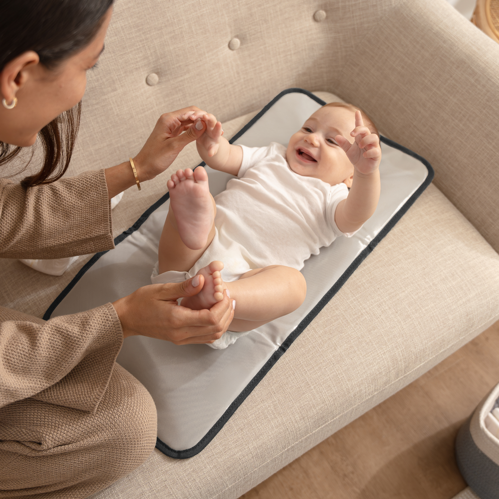 Compact black changing pad for babies, perfect for on-the-go diaper changes.
