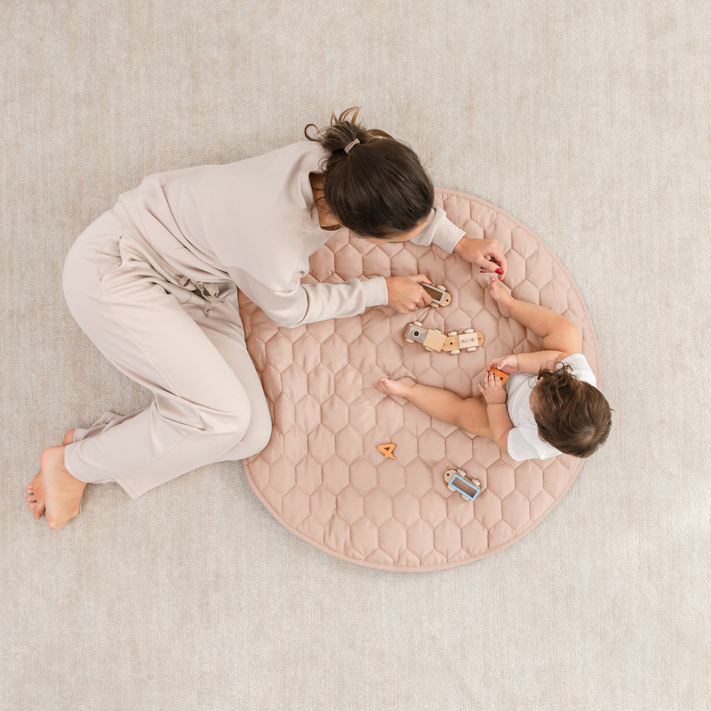 Blush play mat with non-slip bottom, perfect for safe and comfortable playtime for babies.