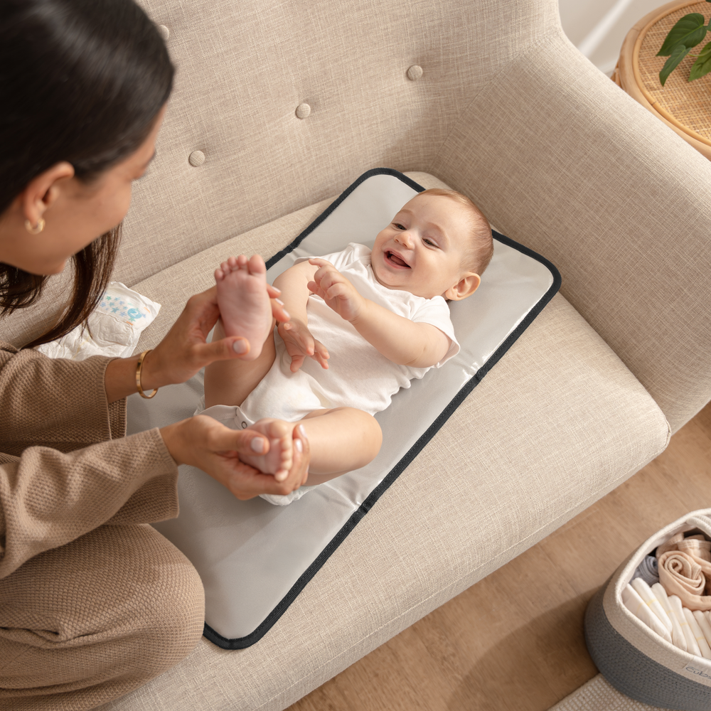 Compact grey changing pad for babies, perfect for on-the-go diaper changes.