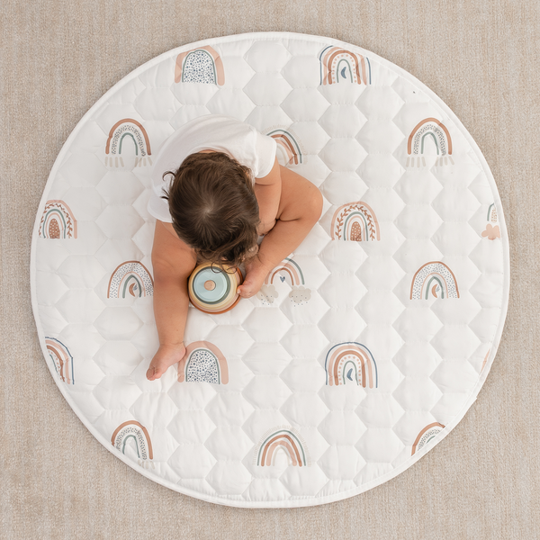 Rainbow play mat with non-slip bottom, angled view showcasing vibrant colors and safe play surface for babies.