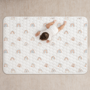 Rainbow play mat with non-slip bottom, angled view, perfect for safe and fun baby playtime.