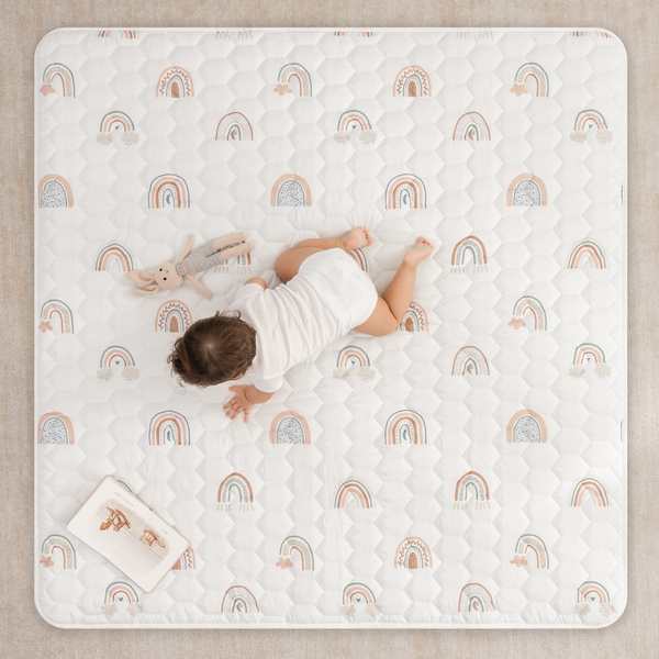Rainbow play mat with non-slip bottom, angled view, perfect for safe and fun baby playtime.