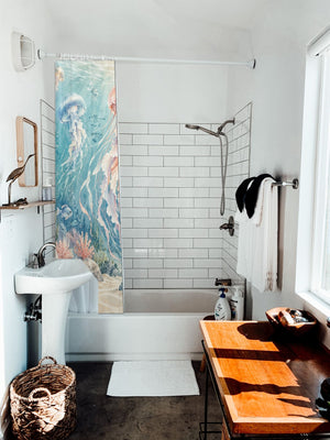 Jellyfish Garden Ocean shower curtain hanging on the rod over a white bathtub