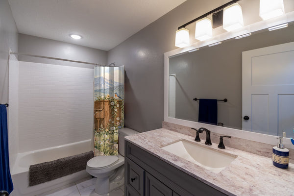 Bear Piano shower curtain pulled open in a gray kids bathroom