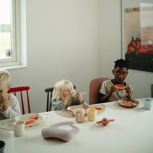 Silicone training cup with straw, angled view, perfect for toddlers learning to drink independently.
