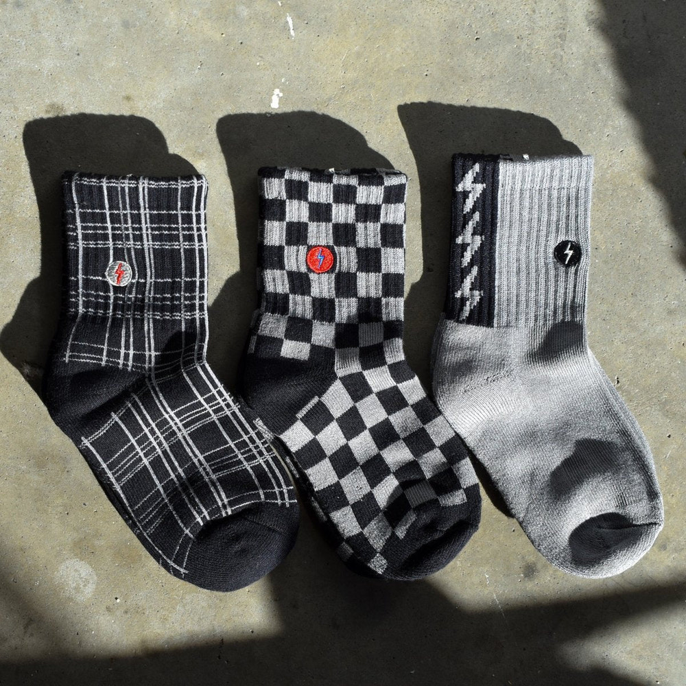 "3-pack 'Check the Volts' baby socks in fun designs, perfect for keeping little feet cozy and stylish."