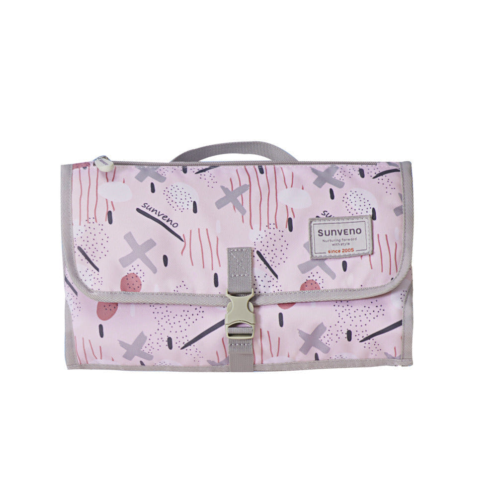 Foldable changing pad for easy diaper changes on the go, featuring a compact design and soft, wipeable surface.