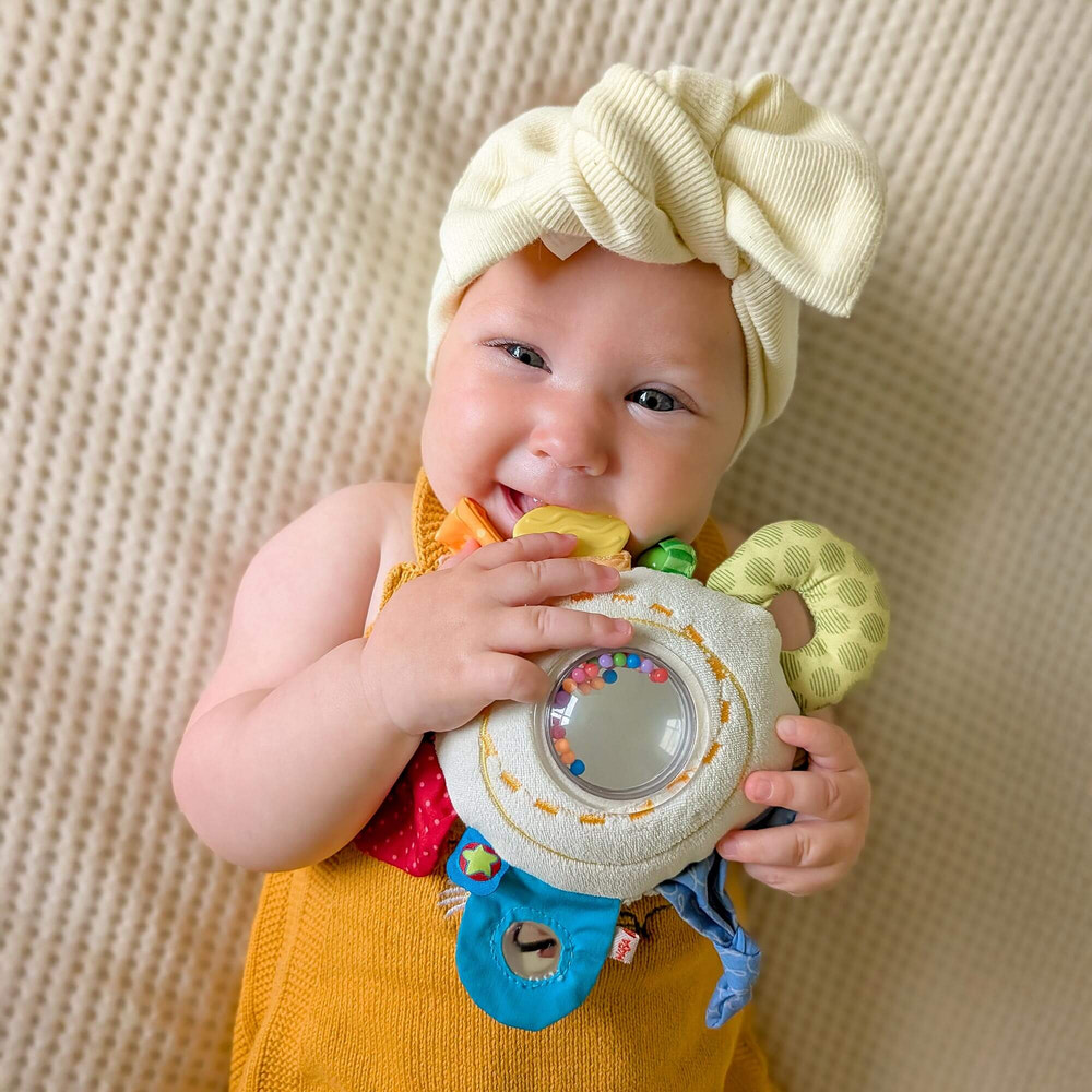 Cuddly Rainbow Round Activity Toy teether for babies, promoting sensory play and soothing relief for teething infants.