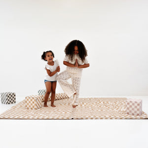 Checker Toffee Organic Cotton Mat for babies, angled view showcasing soft, stylish design for playtime comfort.