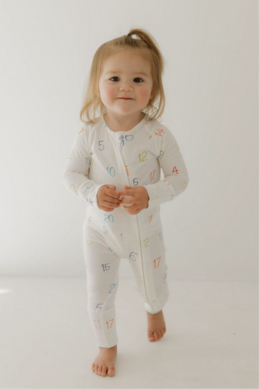 Bamboo zip pajamas for babies, featuring Autism Awareness design by Charli Counts. Soft, eco-friendly, and stylish.