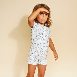 Short sleeve rashguard swimsuit in Scandi floral design, UPF protection, eco-friendly recycled material, angle view.