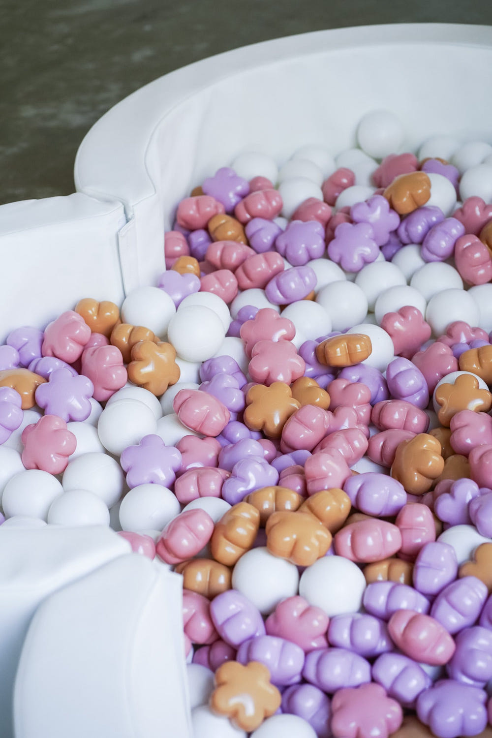 Colorful FLORA ball pit balls for babies, perfect for playtime and sensory exploration in carriers and slings.