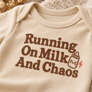 Close-up of the Running On Milk And Chaos baby bodysuit print