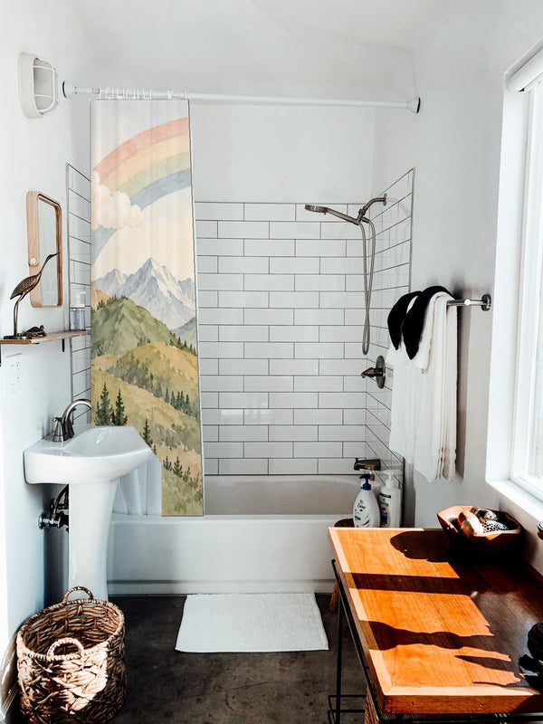 Golden Valley Rainbow shower curtain hanging on the rod over a white bathtub