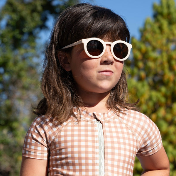 Short sleeve rashguard swimsuit in Sienna Gingham, UPF protection, eco-friendly design, angle view.