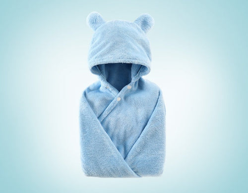 Cotton hooded bath towel for babies, soft and cozy, angled view showcasing its design and texture.