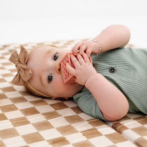Checker Toffee Organic Cotton Mat for babies, soft and stylish play mat in a cozy angle view.