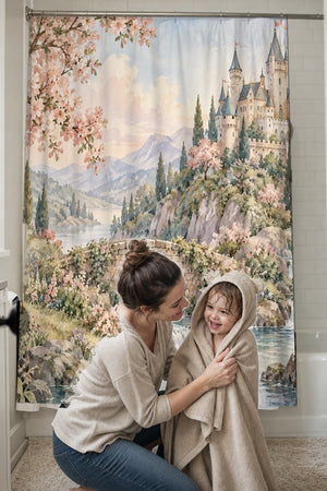 Mom drying her toddler in a hooded towel in front of the Woodland Castle Fairy Tale shower curtain