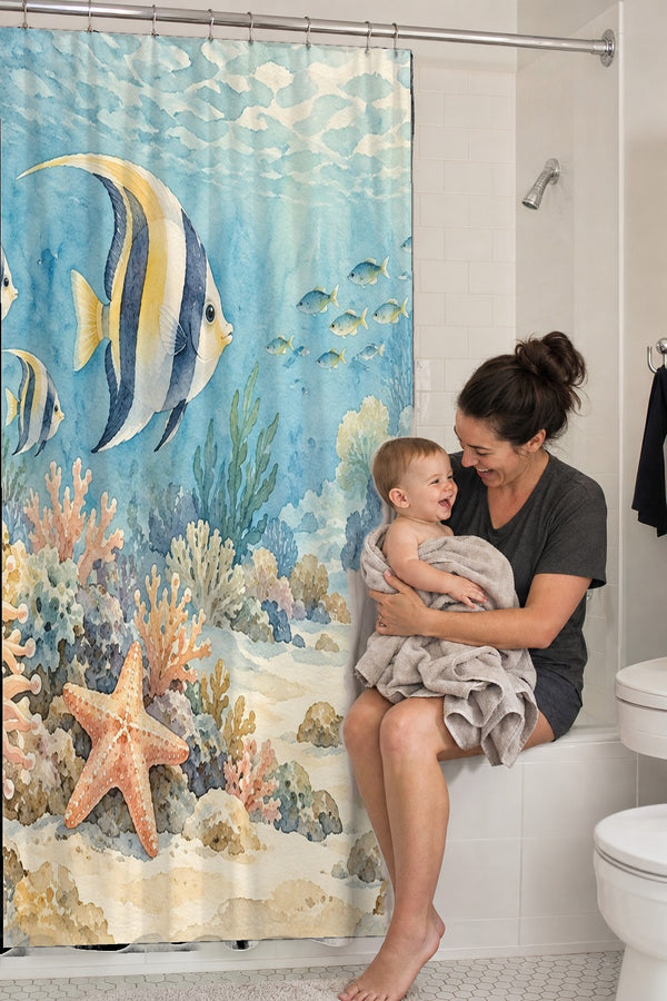 Mom holding her baby on the tub edge next to the Coral Reef Ocean shower curtain