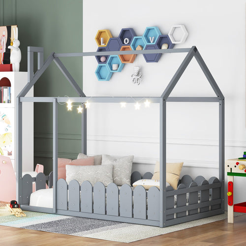 Twin size gray wood house bed frame for kids with fence, angle view, slats not included.
