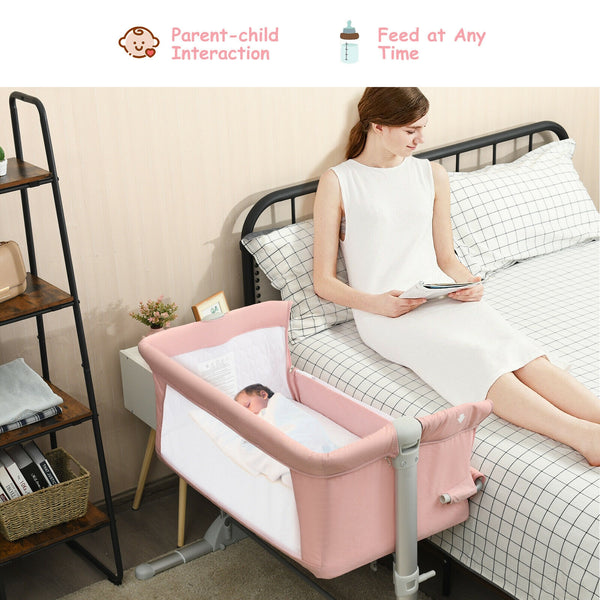 Portable baby bed side sleeper bassinet crib with carrying bag, angled view for travel convenience.