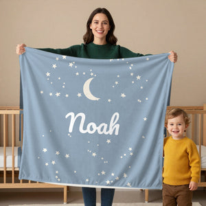 Moon and Stars toddler minky blanket in dusty blue, held by a mom