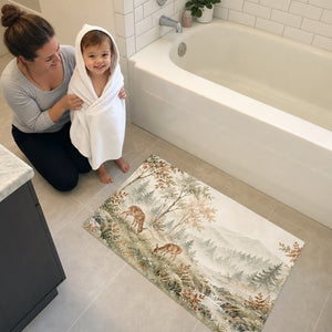 Mom and toddler in a hooded towel next to the Grazing Fawns bath mat