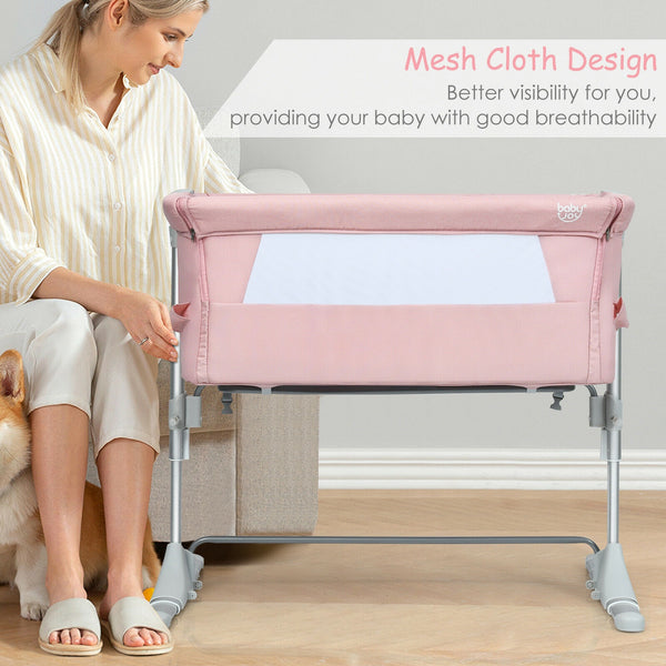 Portable baby bed side sleeper bassinet crib with carrying bag, angled view for travel convenience.