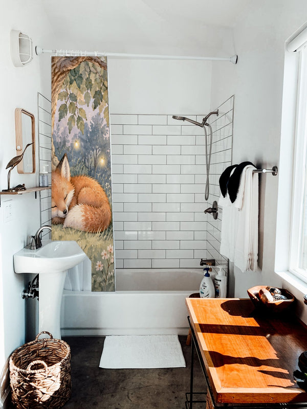 Sleepy Fox shower curtain hanging on the rod over a white bathtub