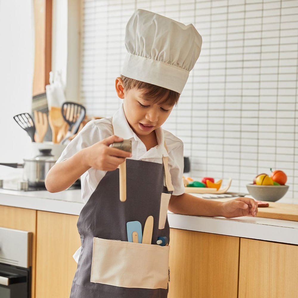 "Colorful baby chef set for imaginative pretend play, featuring utensils and a chef hat."