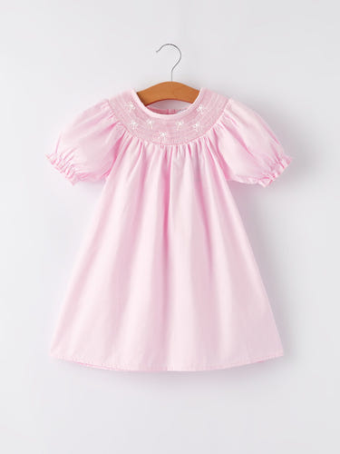 White bow smock embroidered pink dress for babies, perfect for special occasions and everyday wear.