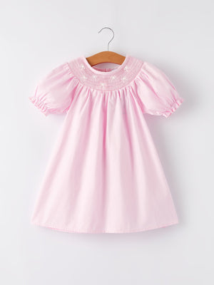 White bow smock embroidered pink dress for babies, perfect for special occasions and everyday wear.