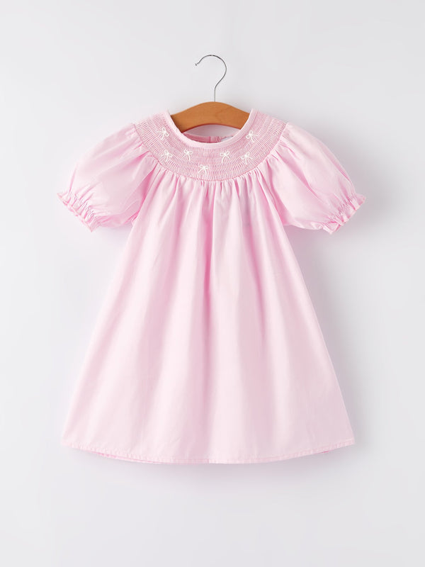 White bow smock embroidered pink dress for babies, perfect for special occasions and everyday wear.
