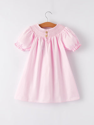 White bow smock embroidered pink dress for babies, shown from angle 2, perfect for special occasions.