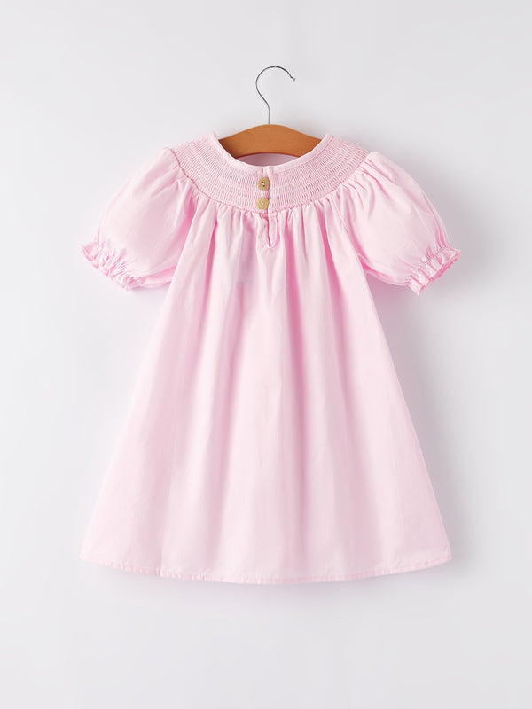 White bow smock embroidered pink dress for babies, shown from angle 2, perfect for special occasions.