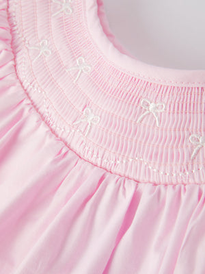 White bow smock embroidered pink dress for babies, showcased from angle 3. Perfect for special occasions.