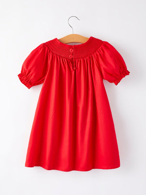Girls red dress with bow smocking and embroidery, shown from angle 4. Perfect for special occasions.
