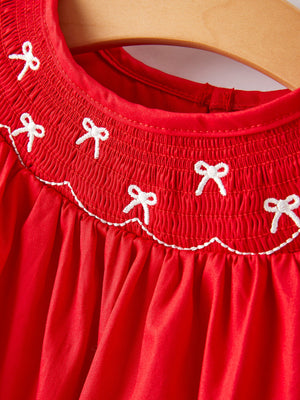 Girls red dress with bow smocking and embroidery, showcased from angle 7. Perfect for special occasions.