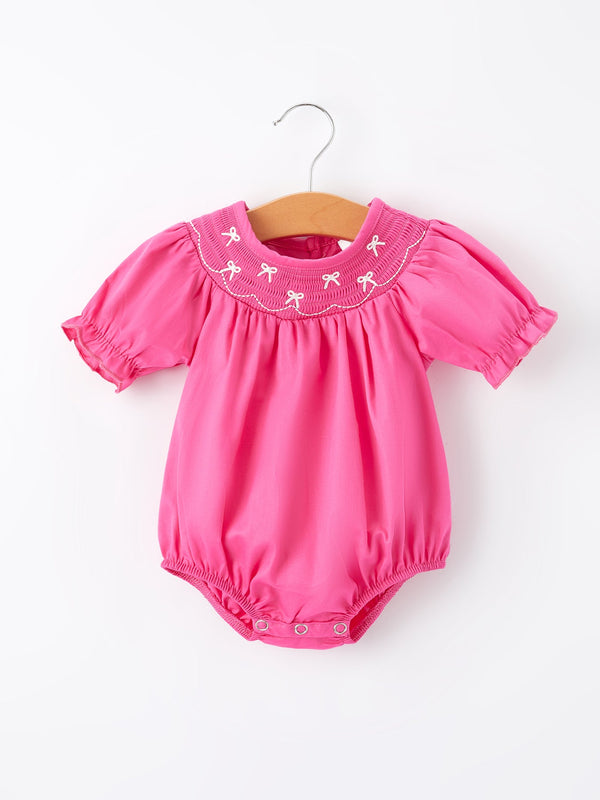 Girls hot pink romper with bow smocking embroidery, perfect for stylish baby outfits.