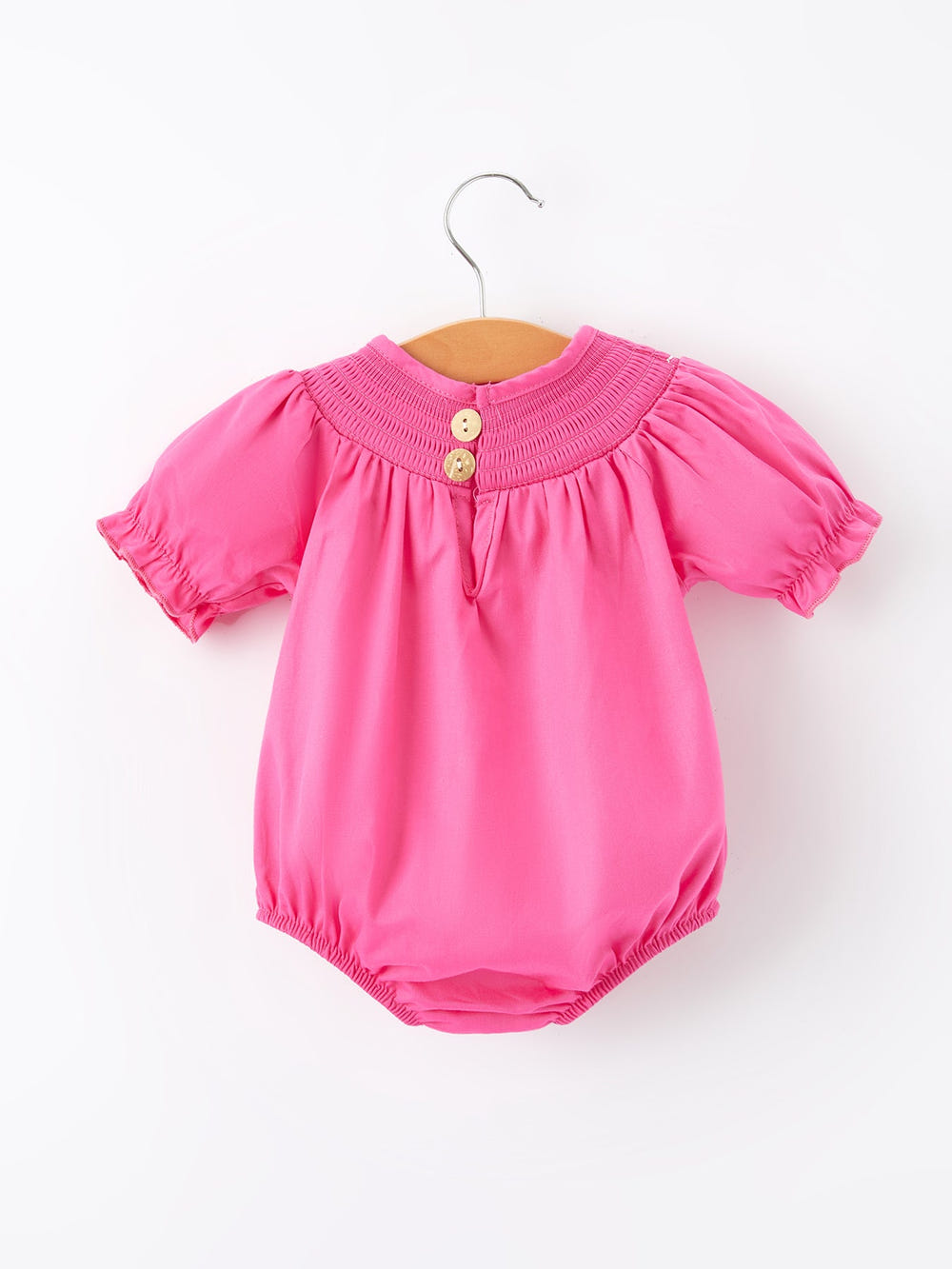 Girls hot pink romper with bow smocking embroidery, perfect for stylish baby outfits.