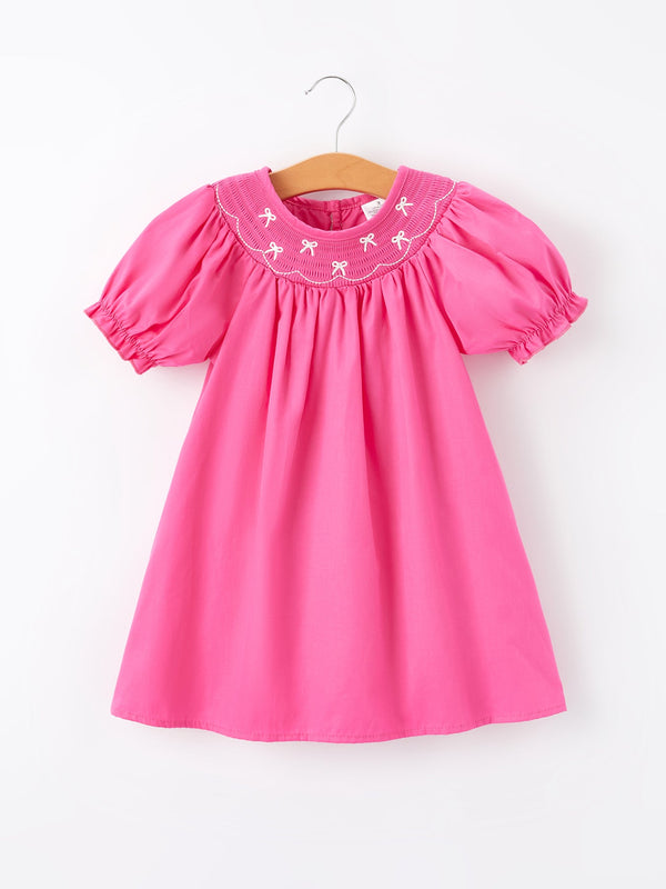 Girls hot pink dress with bow smocking embroidery, perfect for special occasions and everyday wear.