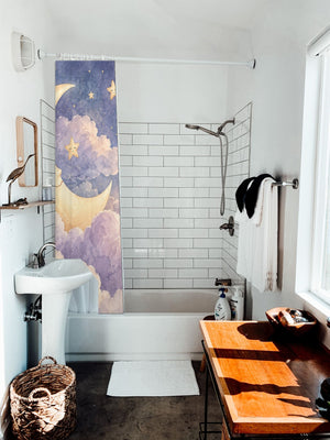 Twilight Moon Hot Air Balloon shower curtain hanging on the rod over a white bathtub