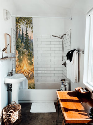 Campfire Friends Camping shower curtain hanging on the rod over a white bathtub