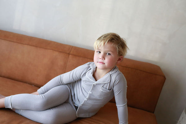 Ribbed Grandpa PJ in Dusty Blue for babies, showcasing cozy bedding and sleepwear from a stylish angle.