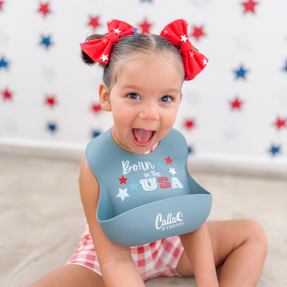 All American Catch All Bib for babies, featuring a fun design and mess-proof catch pocket for easy feeding.