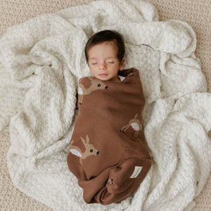 Luxury cotton deer knit swaddle baby blanket in angle view, perfect for cozying up your little one.